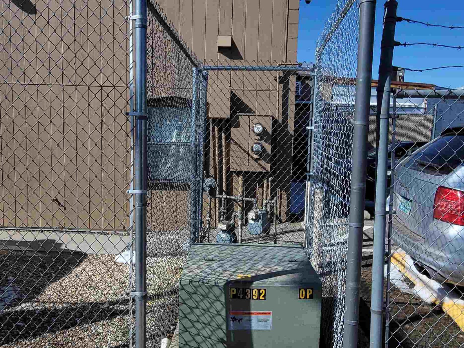 Chain link fence installed around a utility box