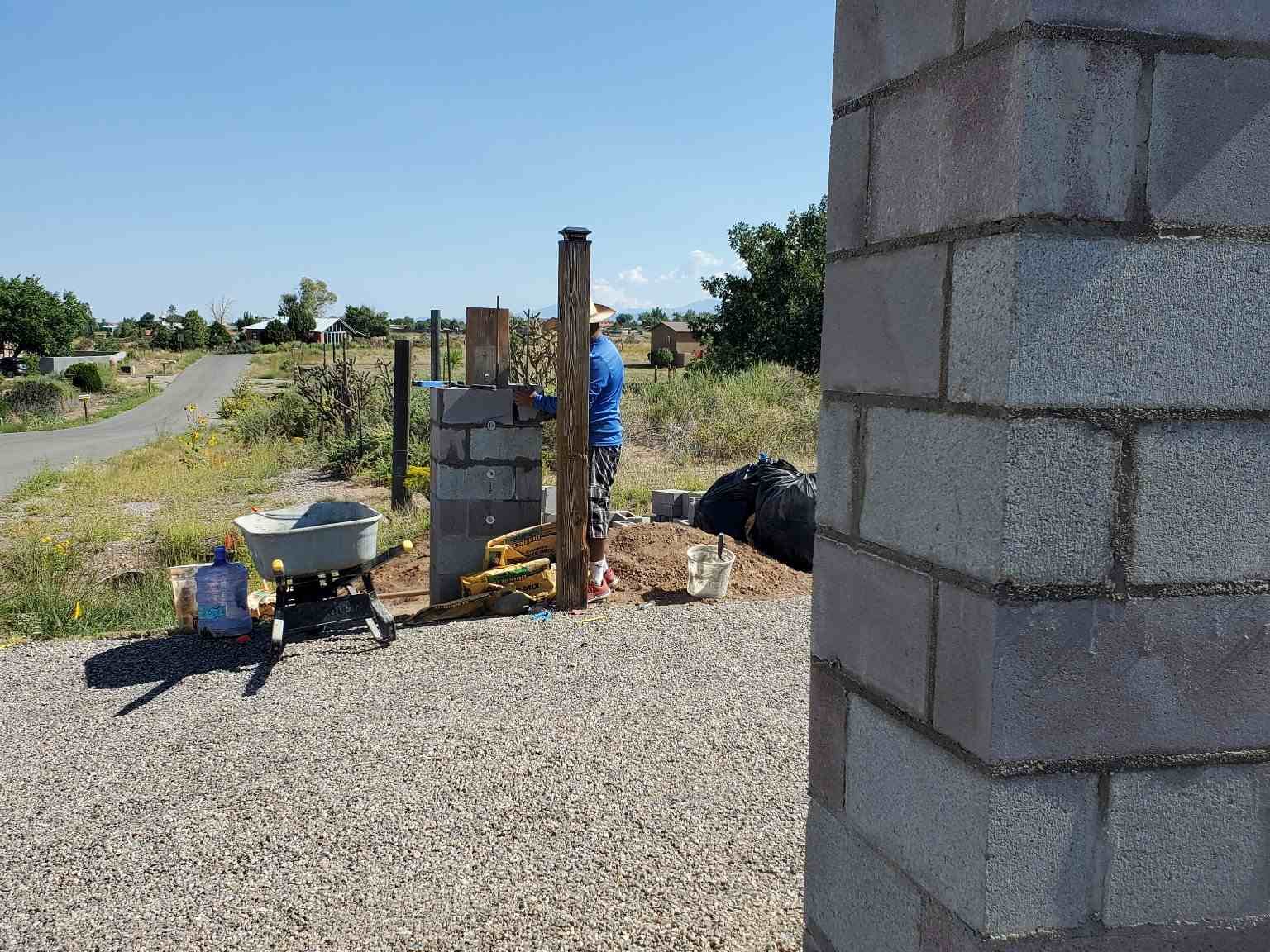 Home in One crew member working on a fence post