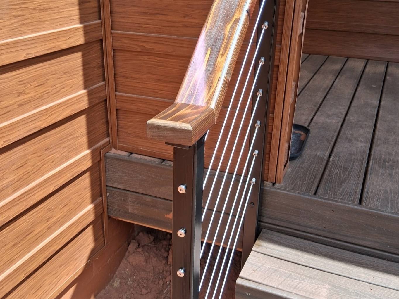 Wooden railing with metal cable design