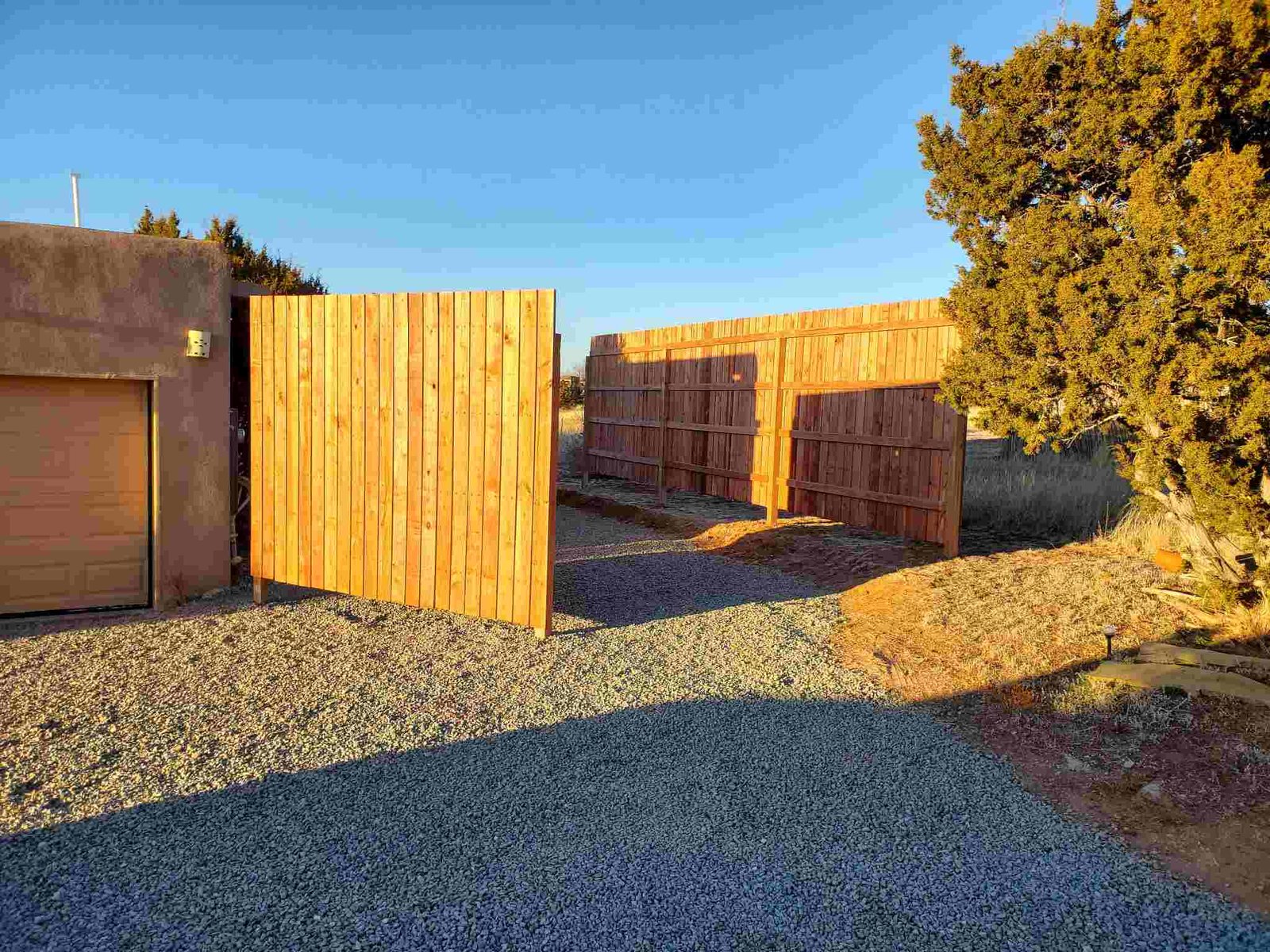 New wooden fence under construction in front of a house